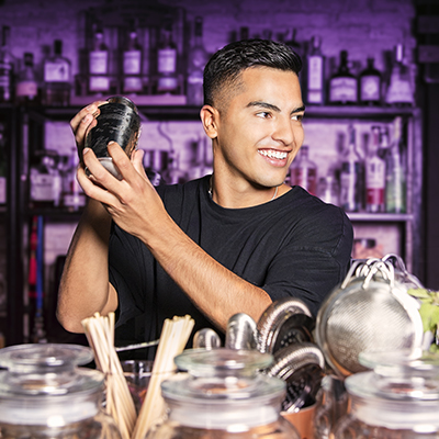 mixologist moves a mixer in a nightclub